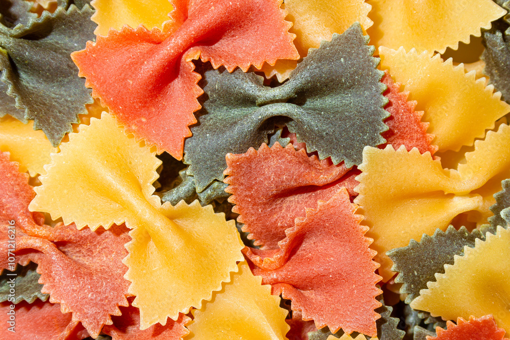 Uncooked Vibrant Colored Farfalle Pasta: A Culinary Canvas of Multicolored Bow-Tie Macaroni, Creating a Lively and Textured Background for Gourmet Cooking Enthusiasts. Colored Dry Pasta. Raw Macaroni Uncooked Vibrant Colored Farfalle Pasta: A Culinary Canvas of Multicolored Bow-Tie Macaroni, Creating a Lively and Textured Background for Gourmet Cooking Enthusiasts. Colored Dry Pasta. Raw Macaroni