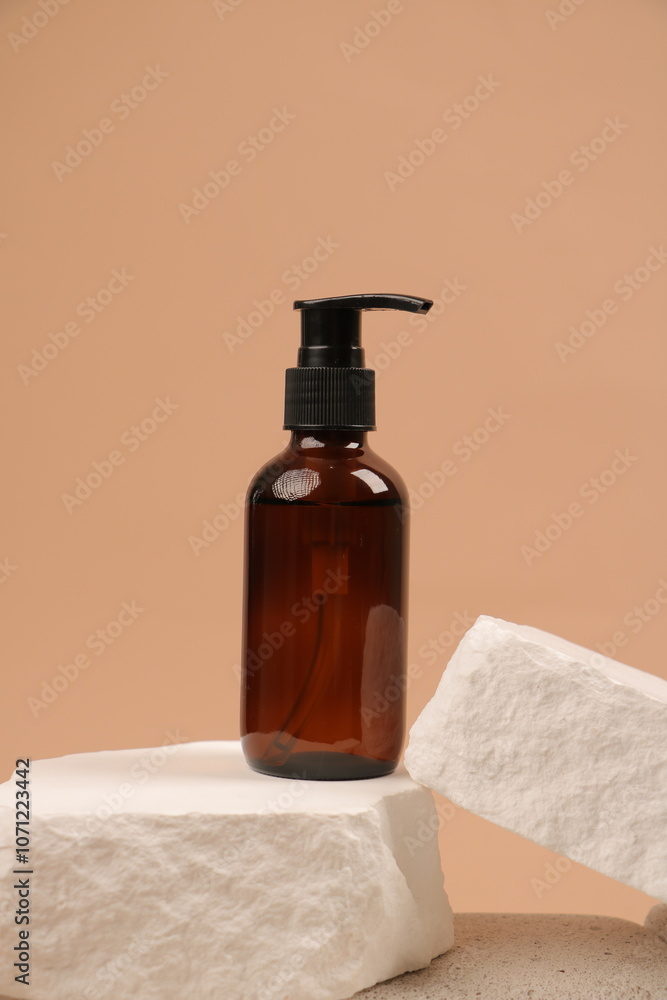 Brown Glass Serum Dropper Bottle on Earthy Mineral Background Brown Glass Serum Dropper Bottle on Earthy Mineral Background