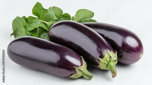 Three ripe eggplants with green leaves on white background.