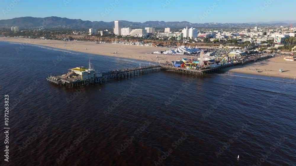 Wide beach overlooking the pier and the amusement park in 4k Wide beach overlooking the pier and the amusement park in 4k