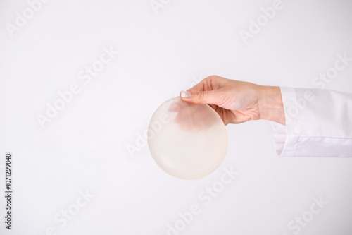 doctor holding breast enlargement implant in hands, plastic surgery concept, beauty enhancement, medical Mammoplasty and plastic surgery, mastopexy