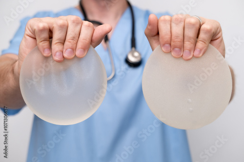 doctor holding breast enlargement implant in hands, plastic surgery concept, beauty enhancement, medical Mammoplasty and plastic surgery, mastopexy photo