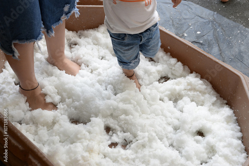 Therapy for children, also known as sensory stimulation, child stepping on sodium polyacrylate, a process that helps children develop their cognitive and psychomotor abilities. photo