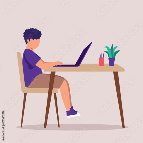 Side View Of One Little Boy Using A Laptop At The Desk.