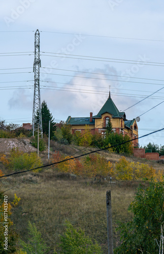 Residential buildings on the mountain behind power lines. photo