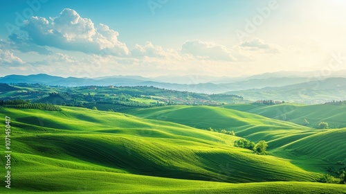 A breathtaking panorama of rolling green hills under a bright sky, showcasing the beauty of nature in a serene landscape.