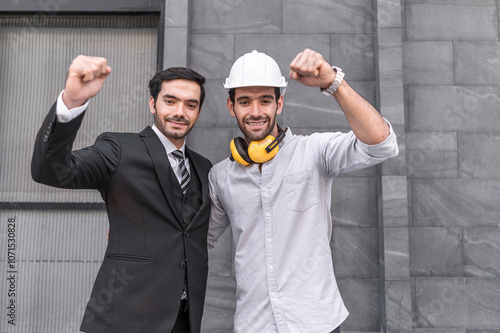 Obraz na płótnie Project engineer and young businessman make high five for success business deal at outdoor office building project. w salonie