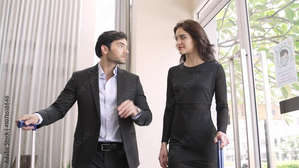 Businessman and woman with travel luggage talking at the hotel Businessman and woman with travel luggage talking at the hotel
