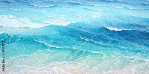 A mesmerizing aerial view of the ocean, showcasing the turquoise and blue hues of the waves as they break on the shore, creating a breathtaking spectacle of nature's beauty.