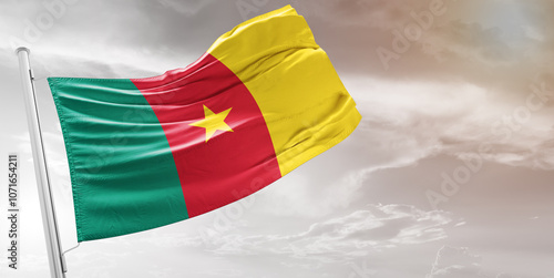Cameroon national flag cloth fabric waving on beautiful grey Background.