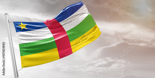 Central African Republic national flag cloth fabric waving on beautiful grey Background.