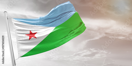 Djibouti national flag cloth fabric waving on beautiful grey Background.