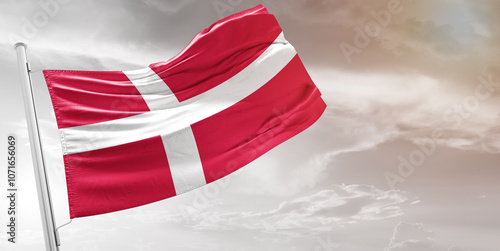 Denmark national flag cloth fabric waving on beautiful grey Background.