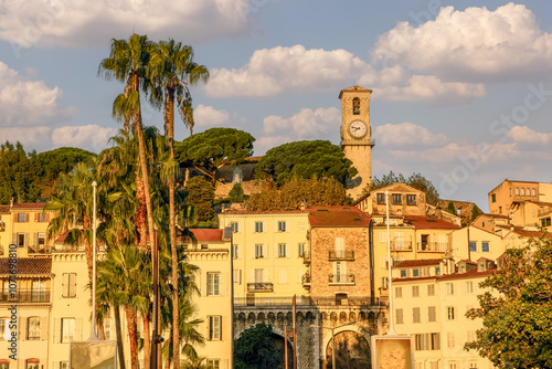 Cannes, France. Picturesque view of the clock tower and the old town of Cannes at golden hour. photo