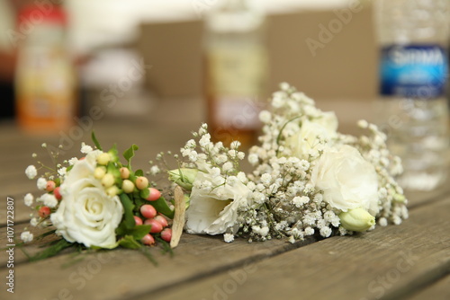 A close-up of a beautiful white rose boutonniere and baby's breath corsage, perfect for a wedding or special event