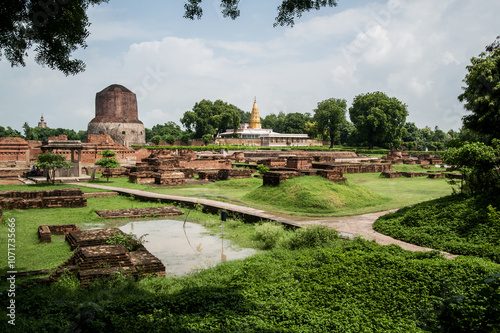 View of the Dhamekh Stupa at the left and the Shri Digambar Jain Temple at the temple of Sarnath 13 kilometres north-east of Varanasi city in India. The temple is an important pilgrimage site. photo