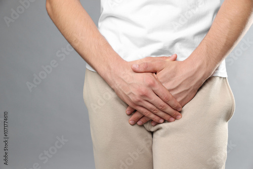 Wallpaper Mural STD (sexually transmitted diseases). Man suffering from symptoms on grey background, closeup Torontodigital.ca