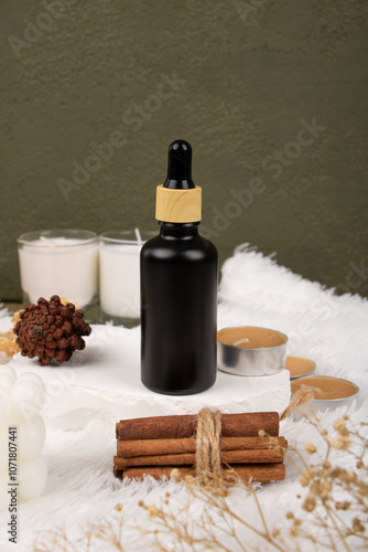 Matte Black Dropper Bottles on Wooden Plate with Natural Elements – Modern Skincare Packaging photo