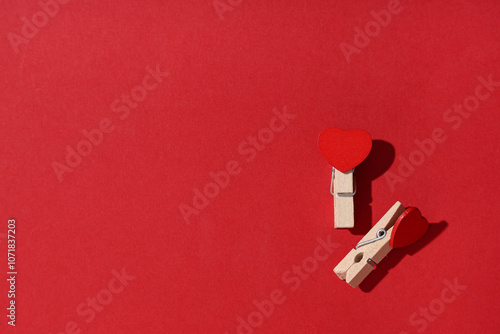 Two wooden clothespins with...