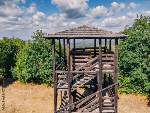 An empty birdwatching tower stands quietly in a national park, offering a serene vantage point surrounded by nature and untouched wilderness