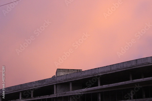 sunset over the roof of a ruined building