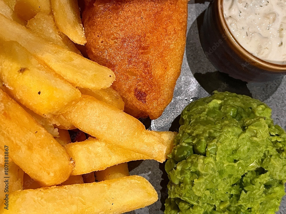 Gourmet British fish and chips and mushy peas with tartare sauce