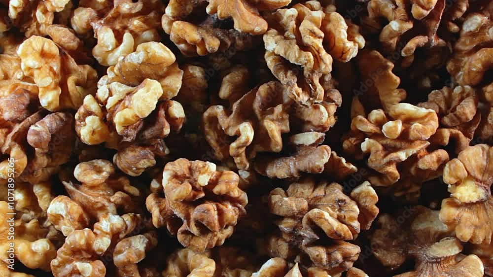 Scattered Shelled Walnuts - Top View, Rotating. Turning Walnut Background. Natural High-Calorie Snacks - Rotation Scattered Shelled Walnuts - Top View, Rotating. Turning Walnut Background. Natural High-Calorie Snacks - Rotation