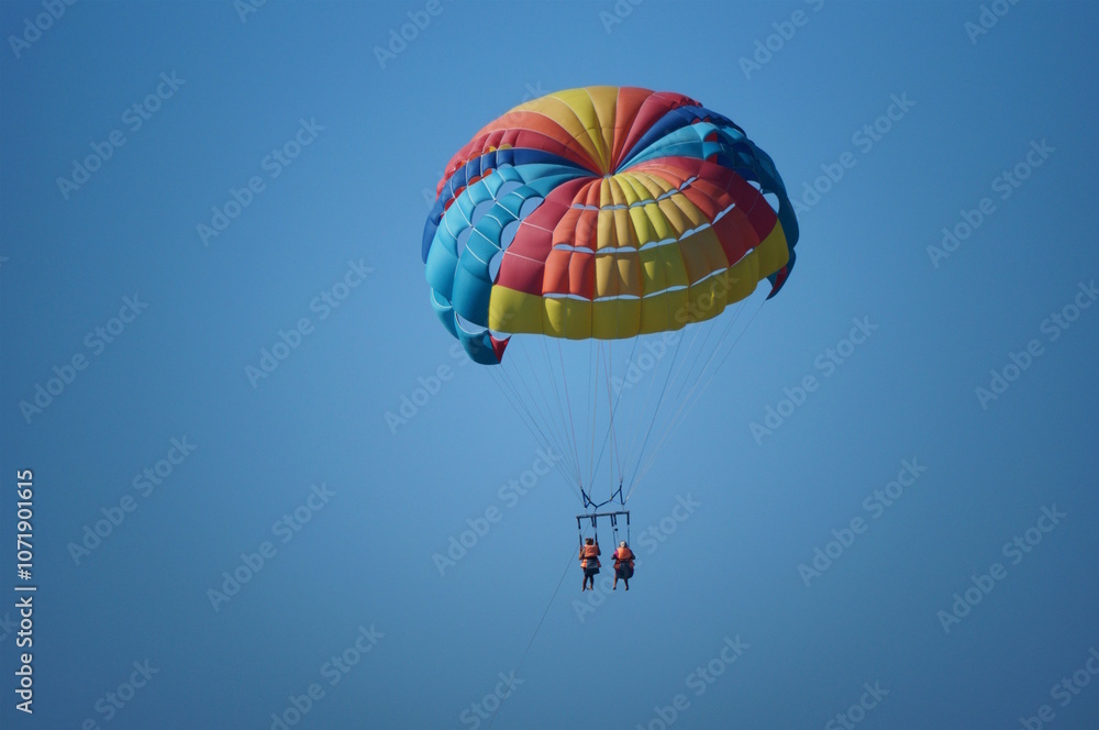 Parasailing. Parachute flight behind the boat. Vacation at the sea. Parasailing. Parachute flight behind the boat. Vacation at the sea.
