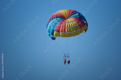 Parasailing. Parachute flight behind the boat. Vacation at the sea.