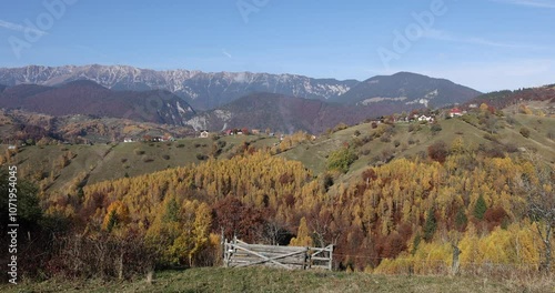 Scenic autumn overview of Magura village in Romania, near the Piatra Craiului mountains.