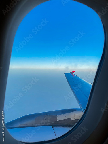 Gazing at the endless sky from the scheduled airplane window.