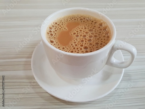 Close up of hot tea with milk or popularly known as Teh Tarik in Singapore and Malaysia