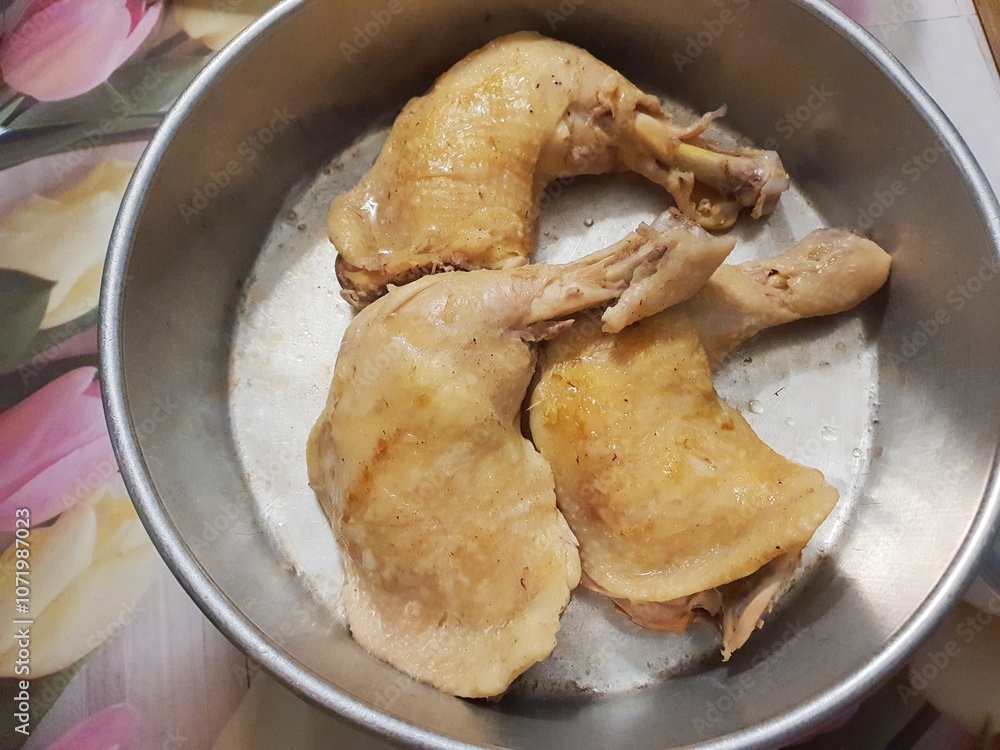 Close up of home cook grilled chicken thigh in a metal tray on a wooden table Close up of home cook grilled chicken thigh in a metal tray on a wooden table