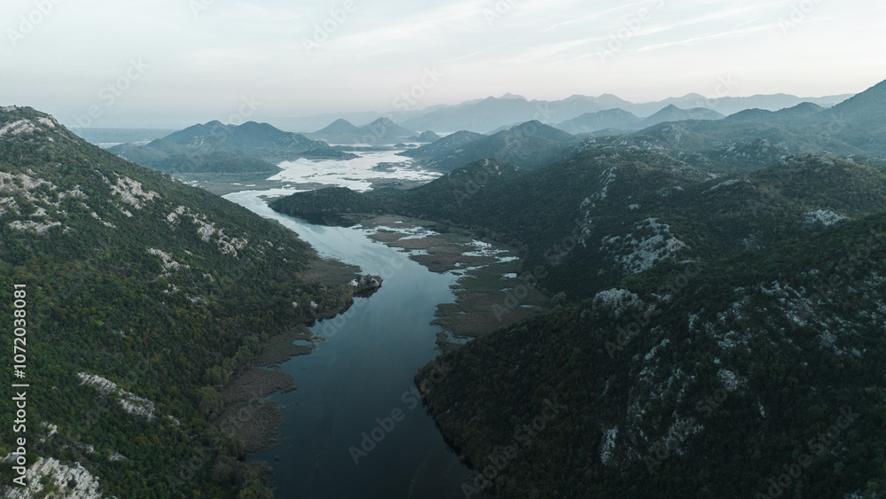 Rijeka Crnojevica river near Skadar lake in Montenegro. A winding river among the rocky mountains. Breathtaking landscape aerial view. Rijeka Crnojevica river near Skadar lake in Montenegro. A winding river among the rocky mountains. Breathtaking landscape aerial view.