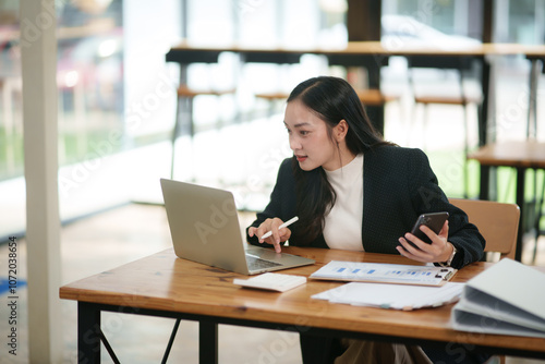 Asian business girl Giving advice to customers via the laptop at the office.	