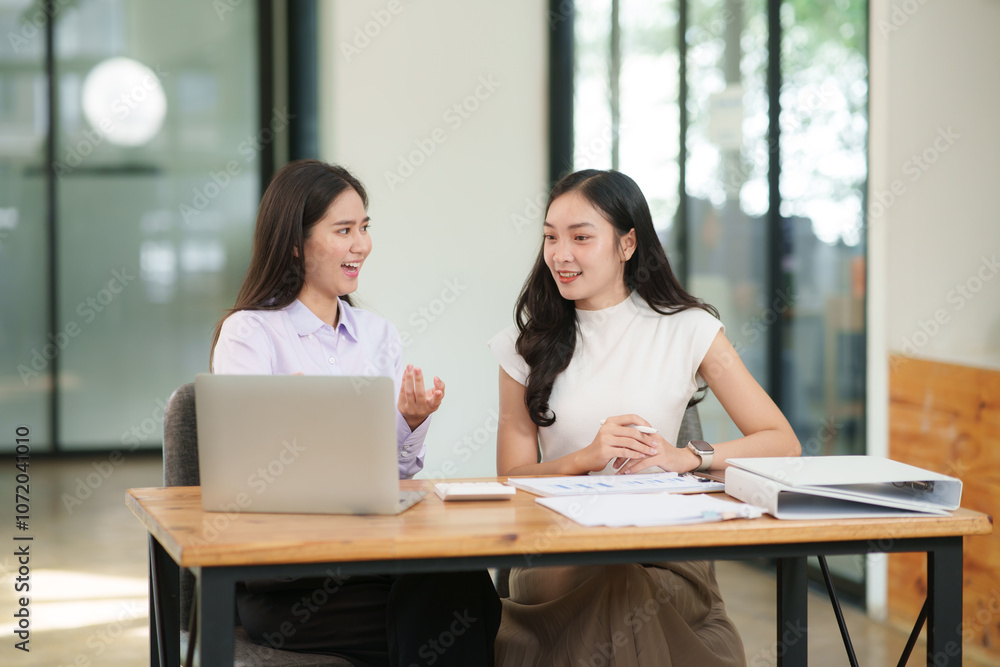 Businessman, two Asian women give advice, discuss work, documents on laptop at office Businessman, two Asian women give advice, discuss work, documents on laptop at office