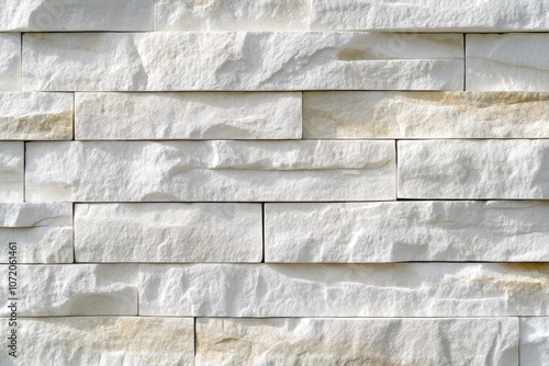 A close-up shot of a white brick wall with small cracks and imperfections photo