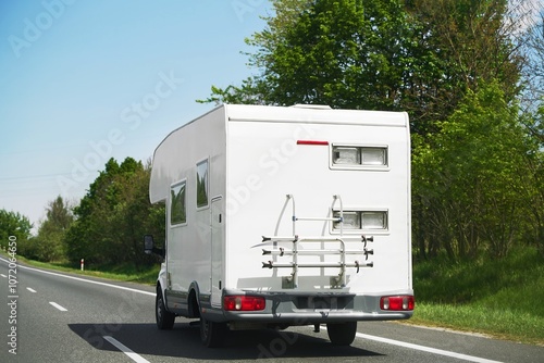 big modern white family rv camper van vehicle driving on european highway