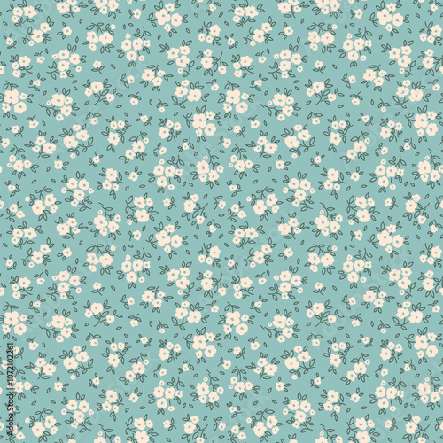 Floral pattern. Pretty flowers on gray blue background. Printing with small white flowers. Ditsy print. Seamless vector texture. Spring bouquet.