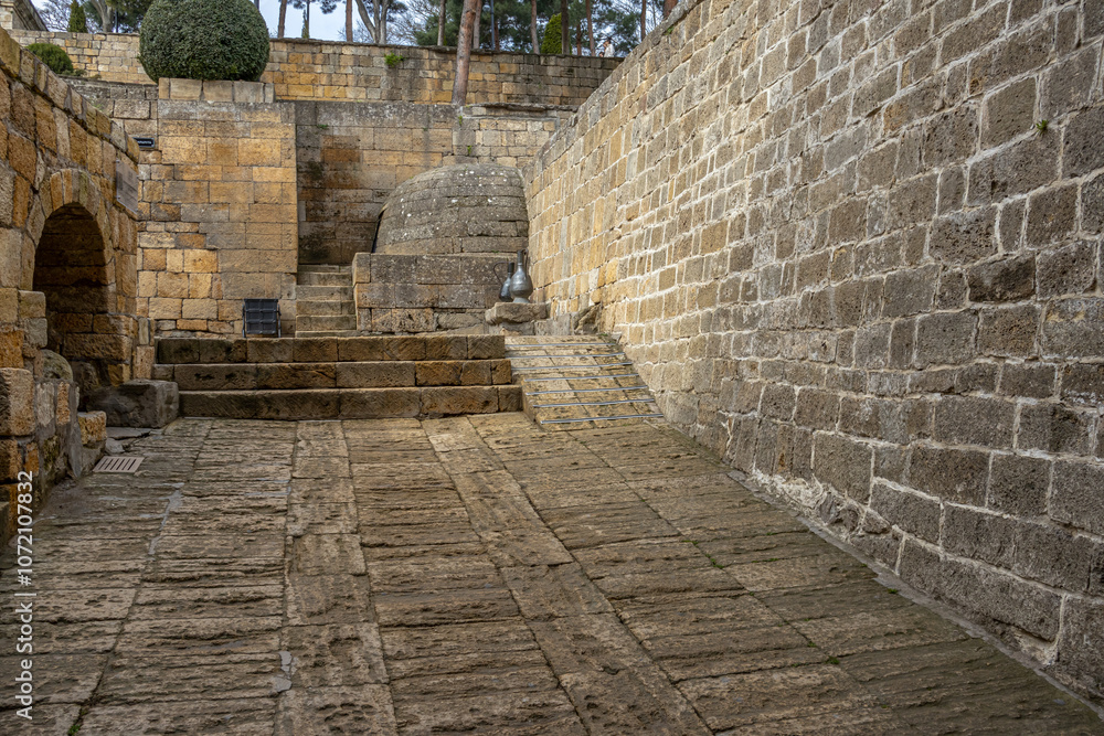 Obraz premium The interior on the street in the ancient city. Stone block walls in the ancient city. Streets in an ancient fortress in the city of Derbent. The Persian citadel.