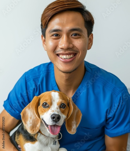 Portrait of a happy young Asian veterinarian with a beagle dog photo