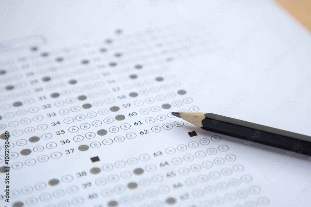pencil on answer sheet; concept of education exam pencil on answer sheet; concept of education exam