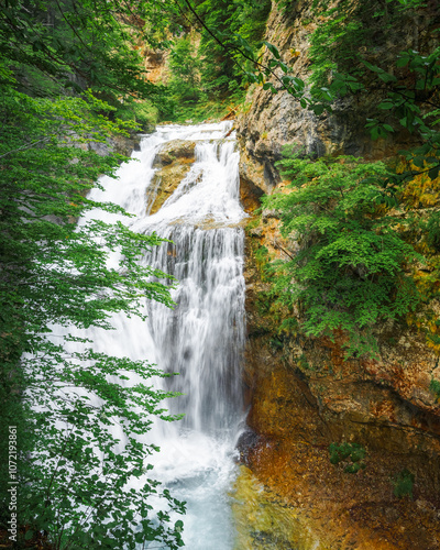 Cave Waterfall vertical view Ordesa y Monte Perdido National Park is in the north of the Iberian Peninsula, nestled in the center of the Pyrenean mountain range, in the Autonomous Community of Aragon. photo