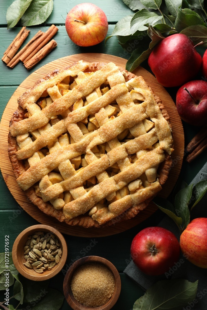 Tasty homemade apple pie and ingredients on green wooden table, flat lay Tasty homemade apple pie and ingredients on green wooden table, flat lay
