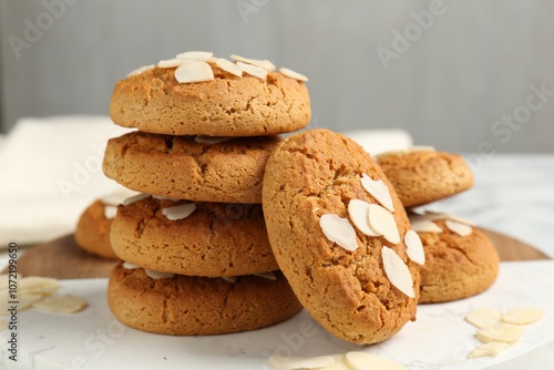 Tasty cookies with almond flakes on table, closeup