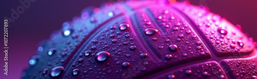 Vibrant water droplets on neon-lit basketball - perfect for sports websites, fitness blogs, motivational posters, or artistic photography portfolios