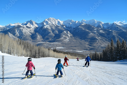 Family enjoying a day on the slopes, children learning to ski with a beautiful view of the mountains behind them, clear skies above. photo