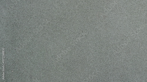 graphic resource of single color gray fine grain rubber crumb coating, full frame, monochrome light textured background with dotted pattern, sports flooring material
