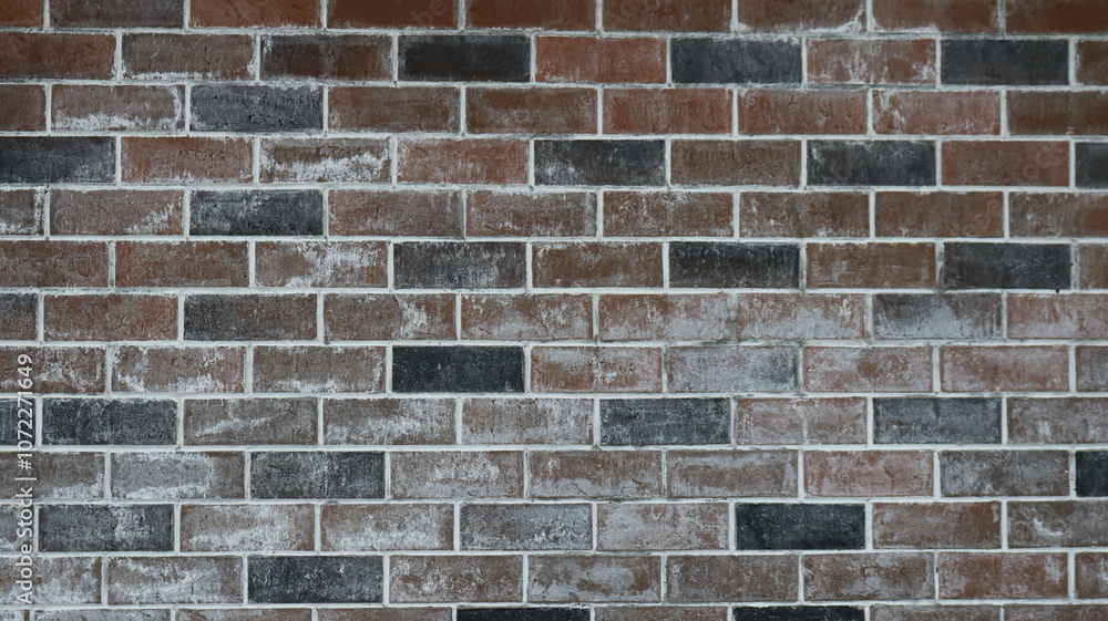 Fototapeta premium wall of black and brown bricks with a touch of white paint or lime as a textured contrasting background, graphic resource with a geometric pattern in a dark style