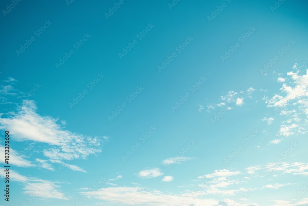 Fototapeta premium Bright Blue Sky with Scattered White Clouds